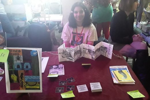 Amanda Hamilton sitting at an expo table.